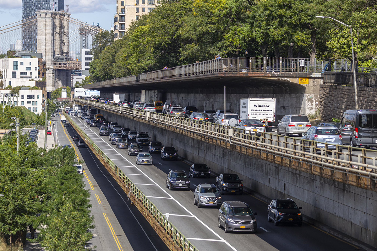 Cars in traffic line an elevated segment of the Brooklyn-Queens Expressway (BQE) in Brooklyn Heights, New York City.