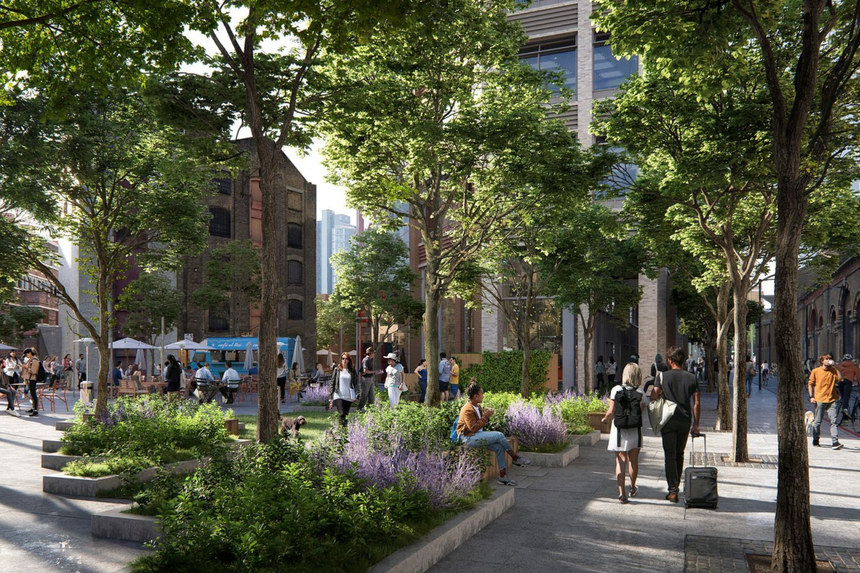 People sit in and stroll through a plaza between city buildings in London, with lush green trees overhead.